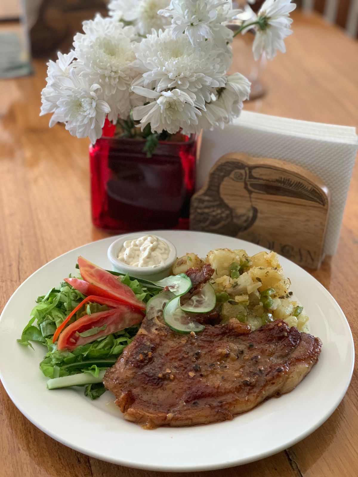 Glazed pork chop plated with salad