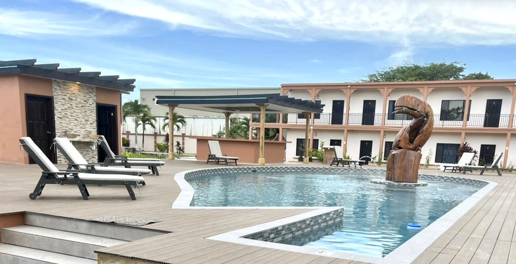 Pool deck with lounge chairs and hotel buildings