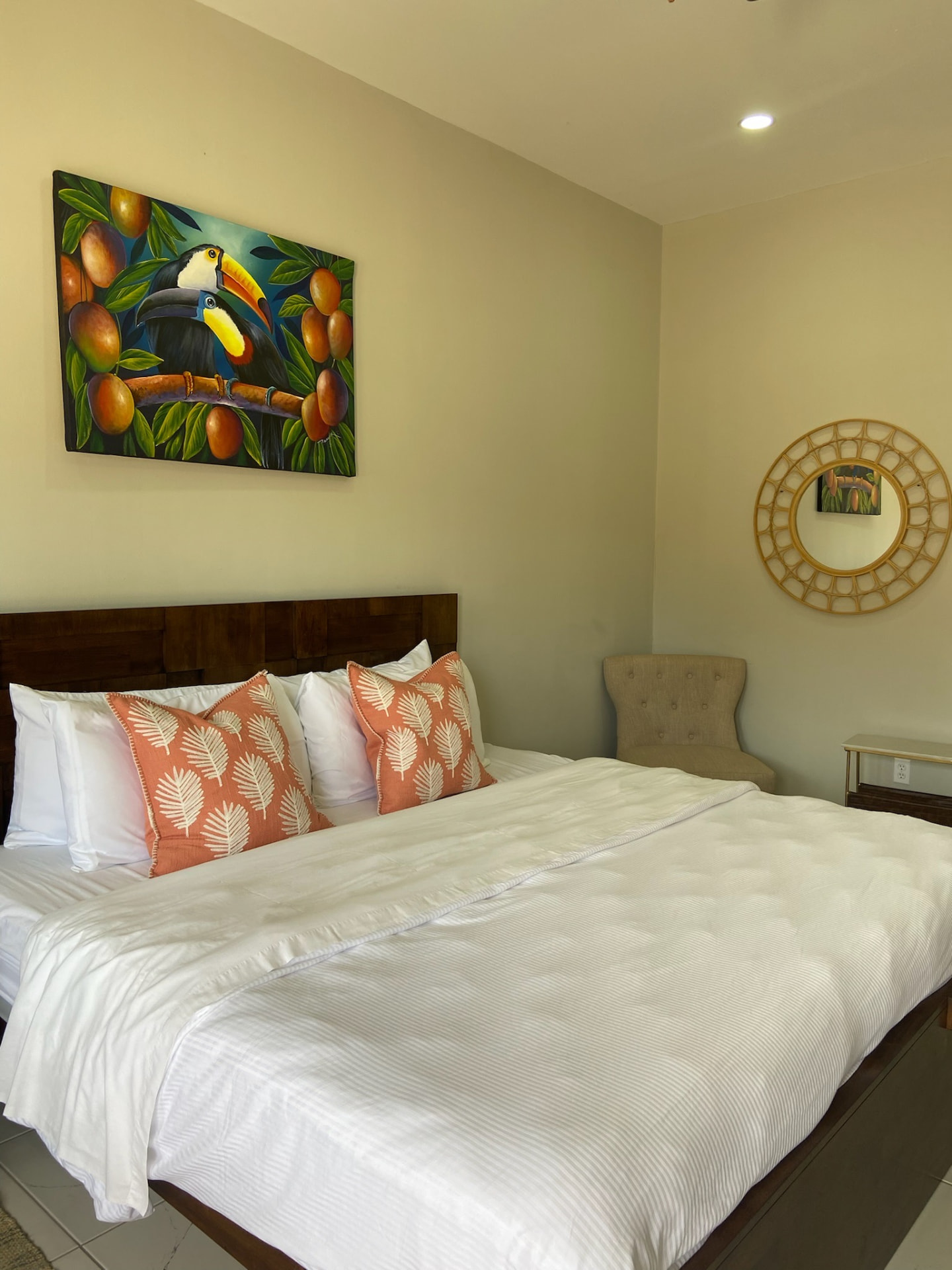 King room with toucan painting above the bed